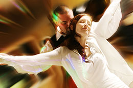 Bride and Groom dance in colored lights