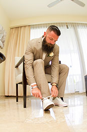 Bearded Groom finishes tying his shoes