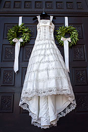Brides dress hangs on the church doors