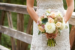 Brides lovely boquet held in front of her