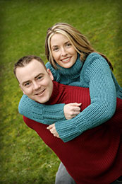 Engaged couple wear warm sweaters in bright colors