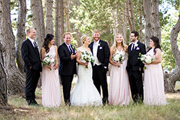 The Wedding party looks great posing in the trees