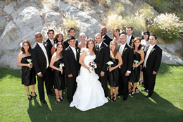 Wedding party poses between the boulders in Palm Desert