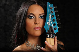 Sexy blue eyed model with blue Ibanez Guitar