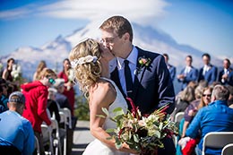 Wedding couple kiss during ceremony at Crystal Mountain