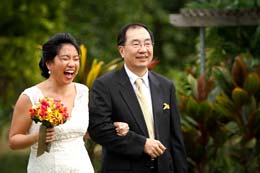 Wedding Photography Bride laughs as she walks down the isle with her father