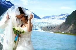 Bride and Groom kiss in front of Mendenhall Glacier in Juneau, Alaska