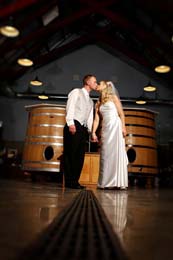 Bride and Groom kiss in the barrel room