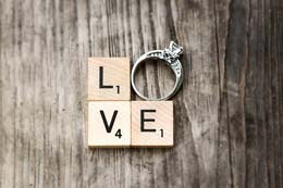 Love spelled with scrabble and a diamond ring