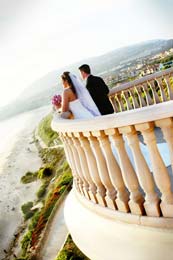 Bride and Groom look out at the Pacific Ocean