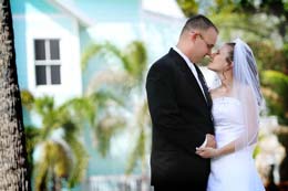 Bride and Groom nussel in front of Florida house