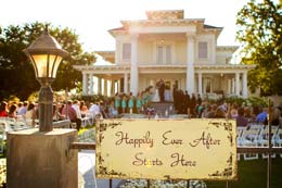 Wedding in the background of a happy sign at Moore Mansion