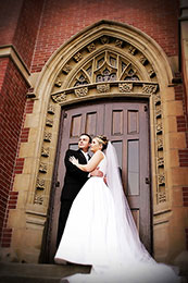 Bride and Groom stand at the doors of Blessed Sacrament in Seattle