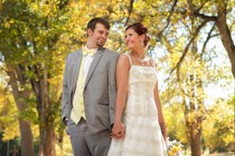Bride and Groom pose under yellow trees