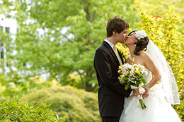 Wedding couple kisses in the garden at the Harbor Club
