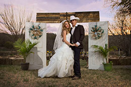 Bride and Groom by old rustic doors in Del Rio, Texas