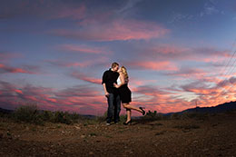 Engaged couple kiss under fierce Phoenix sky