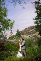 Bride and Groom kiss in the sunset at Thompson River University