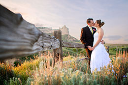 Wedding couple kisses with Scotts Bluff Monument in background