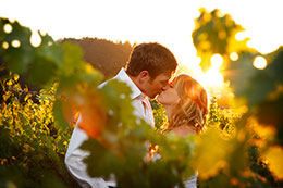 Enaged couple kiss in the Regusci Vineyards near Napa, California