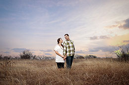 Engaged couple poses under Texas sunset