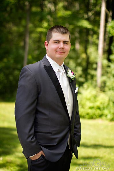 Groom stands along gravel driveway in Cass Lake, Minnesota