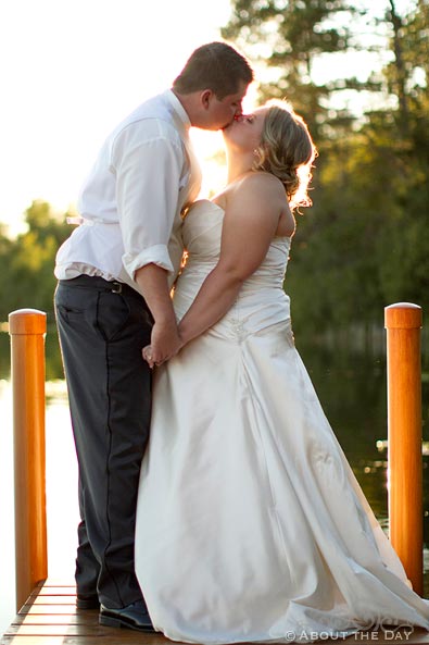 Bride and Groom kiss on the dock at sunset near Cass Lake, Minnesota