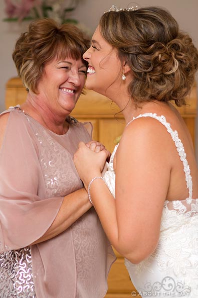 Mother and Bride laugh while getting ready