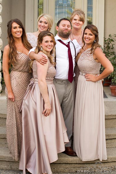 Groom poses with the Bridesmaids