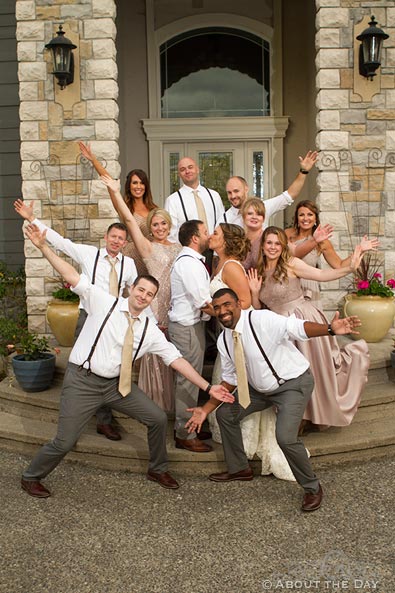 Wedding party gets crazy while the couple kisses