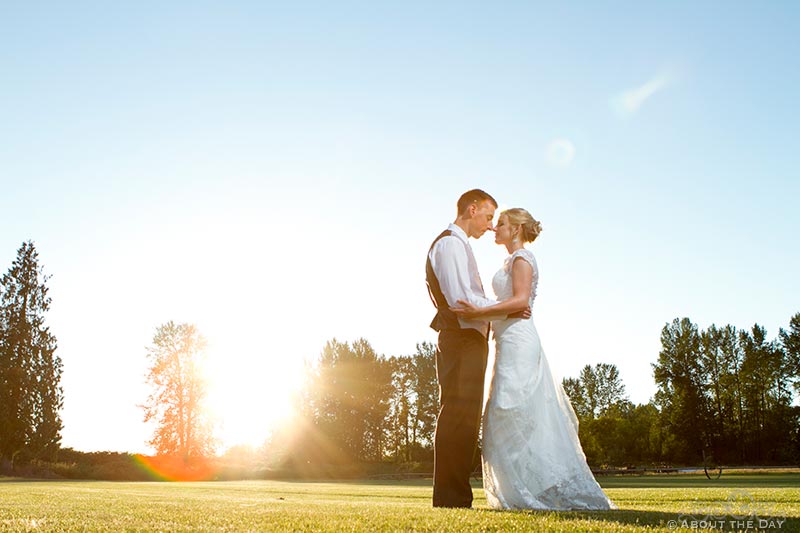 Bride and Groom stand head to head in the sunset at Hidden Meadows