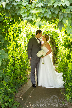 Bride and Groom kiss in the ivy tunnel