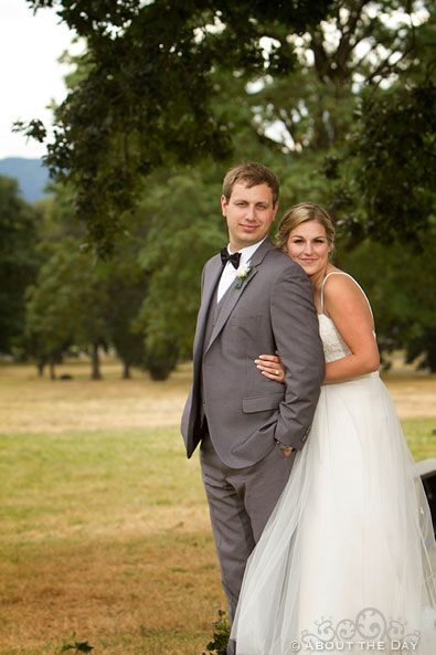 Bride and Groom pose in field at Officers Row
