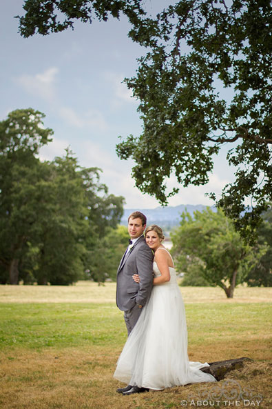 Bride and Groom pose in field at Officers Row