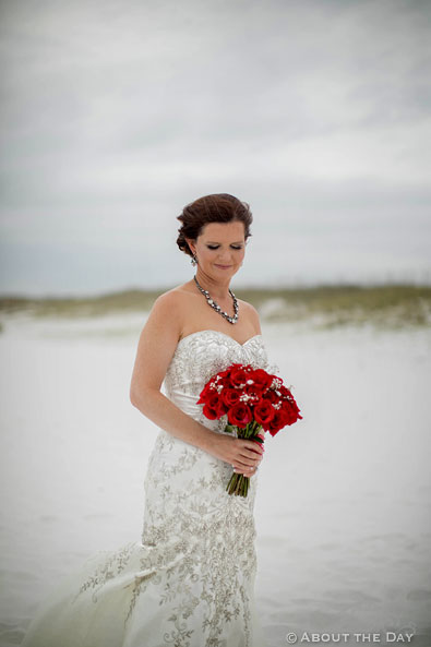 Beautiful Bride with red rose boquet on Princess Beach in Destin, Fl