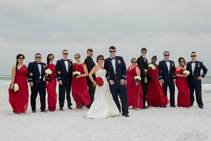 Full Wedding party poses during wind storm at Princess Beach in Destin, Fl