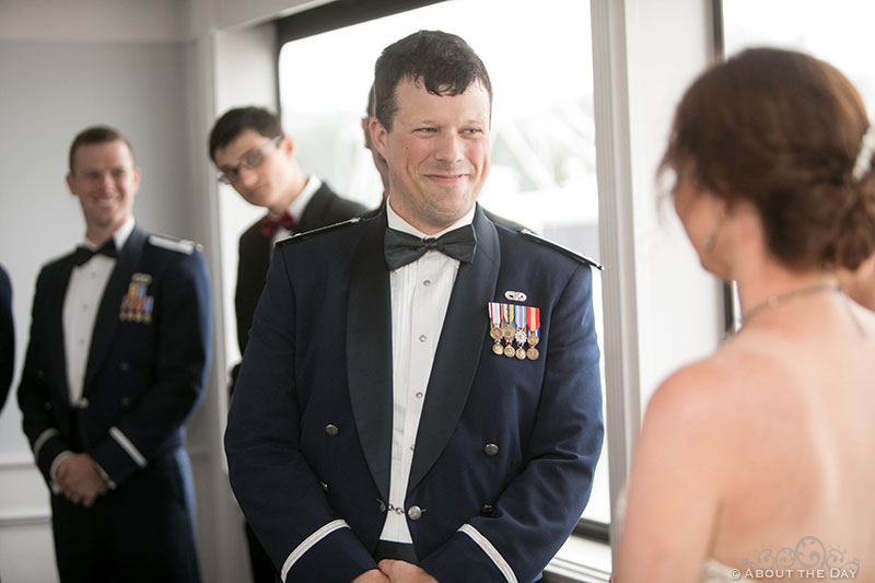 Josh grins at Rebecca during wedding ceremony on the Solaris Yacht in Miramar Beach, FL