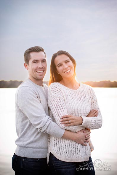 Engaged couple snuggles in white at Green Lake