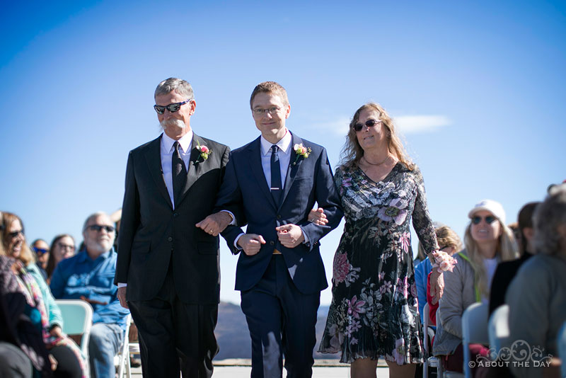 Andrew escorts his parents down the isle
