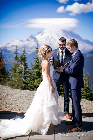 Andrew & Alex exchange rings with a beautiful view of Mt. Ranier behind them