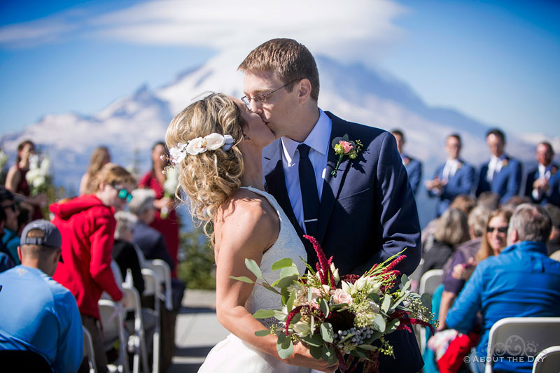 Andrew & Alex kiss during the wedding recessional at Crystal Mountain