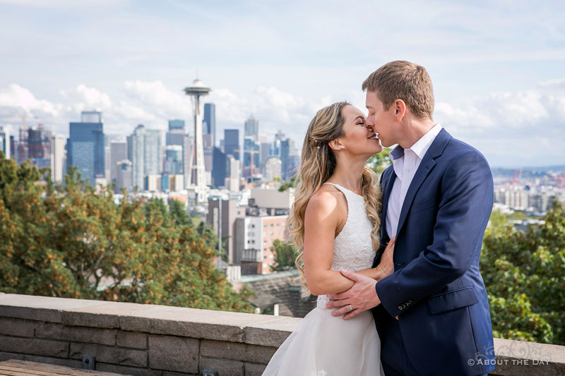 Andrew and Alex kiss at Kerry Park with Seattle in the background
