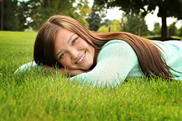 Katelin lays on the grass for senior photos in Lacey, Washington