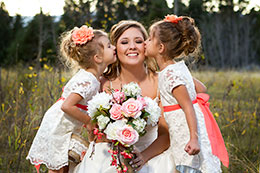 Flowergirls kiss the bride