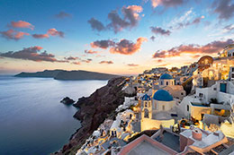 Oia lights up during a spectacular sunset in Santorini