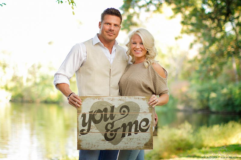 Engaged couple with You & Me sign at Rock Cut Park