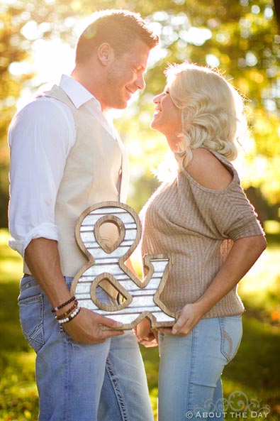 Engaged couple with an & sign at Rock Cut State Park