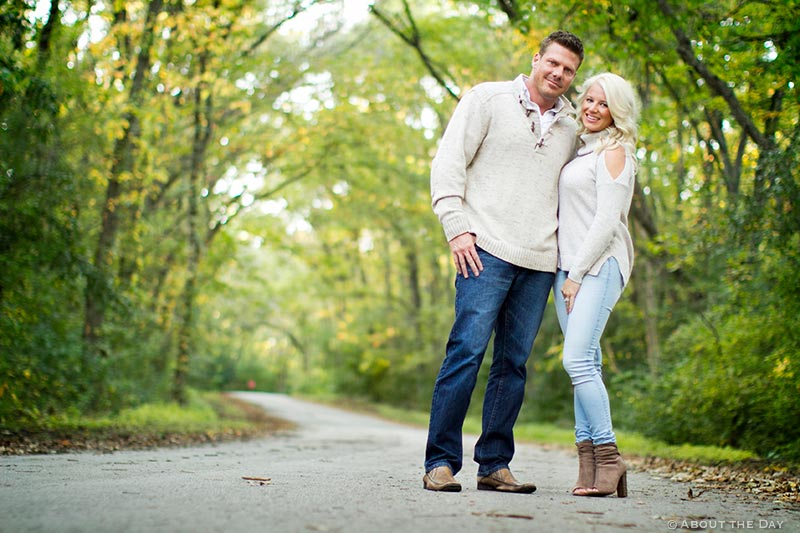 Engaged couple along a treelined road at Rock Cut State Park