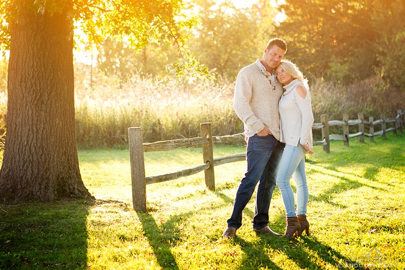 Engaged couple along a wood fence at Rock Cut State Park