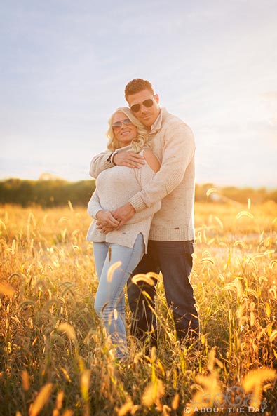 Engaged couple stand in the tall grass near Rockfort, IL